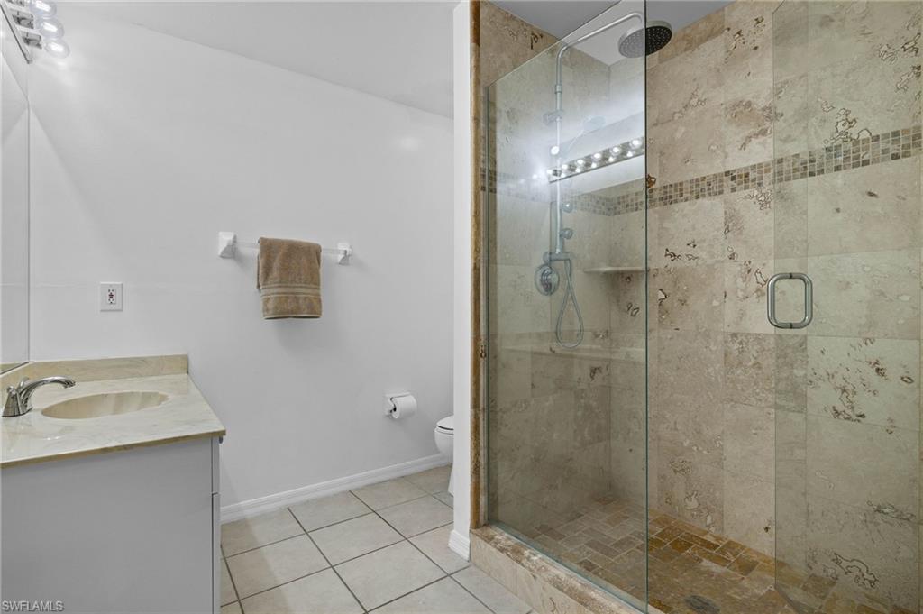 14817 Laguna Drive, Unit 203 Fort Myers, FL 33908 - Photo 24 of 42 a bathroom with a shower sink and mirror