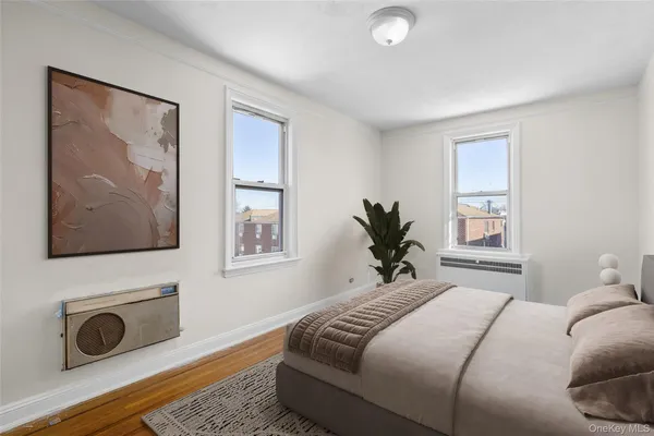 a bedroom with a bed and a painting on the wall