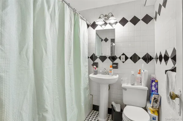a white toilet sitting next to a bathroom sink