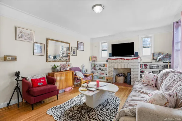 a living room with furniture a flat screen tv and a fireplace