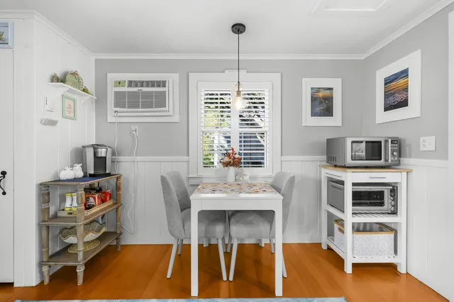 a living room with furniture a flat screen tv and a table