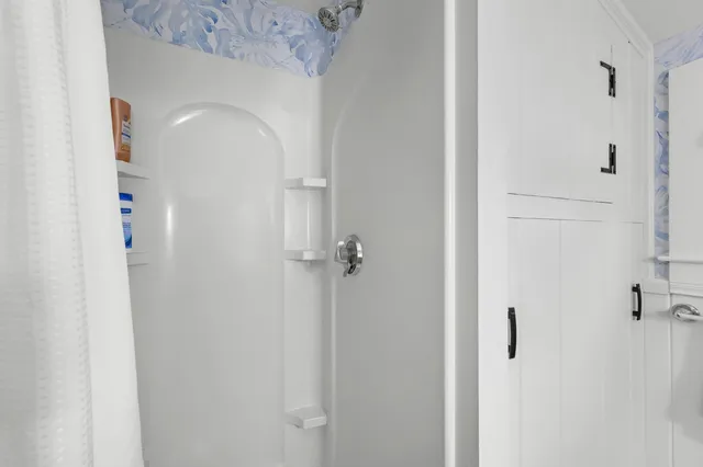 a bathroom with a glass shower door