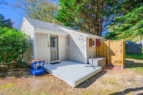 a view of a lounge chair in the back yard of the house