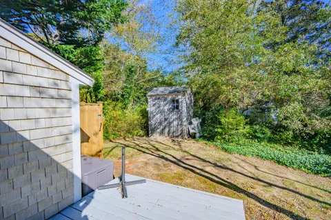a wooden bench sitting in front of a building