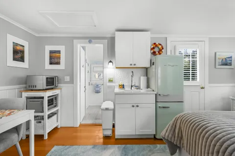 a bedroom with a bed and a desk in it