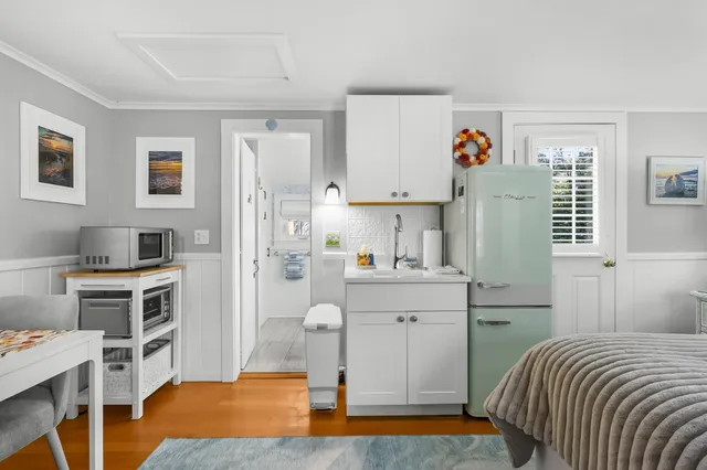 a bedroom with a bed and a desk in it