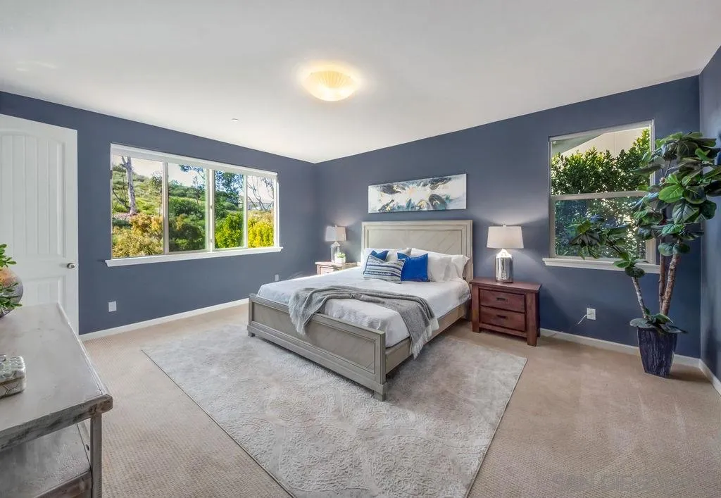 17568 Ralphs Ranch Road San Diego, CA 92127 - Photo 11 of 25 a bedroom with a large bed and a potted plant