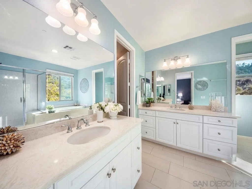 17568 Ralphs Ranch Road San Diego, CA 92127 - Photo 13 of 25 a bathroom with double sink and a mirror
