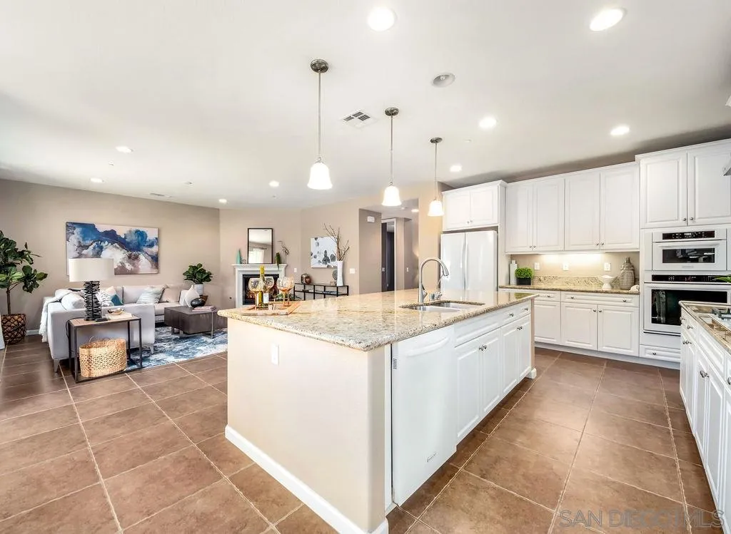 17568 Ralphs Ranch Road San Diego, CA 92127 - Photo 5 of 25 a large white kitchen with lots of counter space and a sink