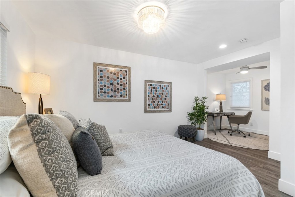 35261 Beach Road Dana Point, CA 92624 - Photo 19 of 45 a bedroom with a bed lamps and a large mirror