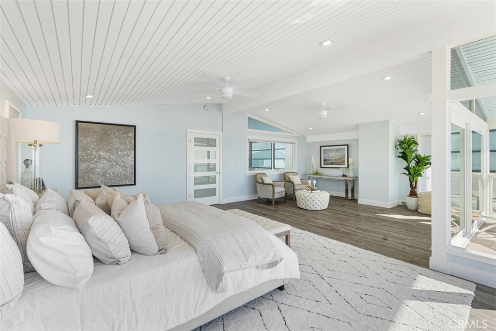 35261 Beach Road Dana Point, CA 92624 - Photo 28 of 45 a spacious bedroom with a bed and glass door