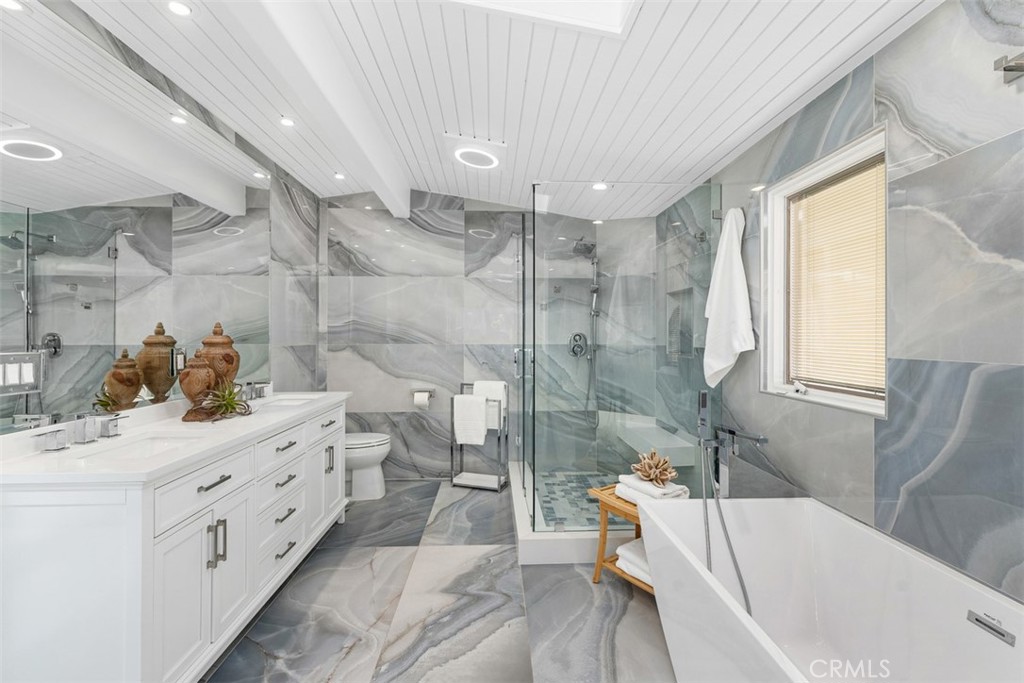 35261 Beach Road Dana Point, CA 92624 - Photo 30 of 45 a bathroom with a double vanity sink a toilet and bathtub