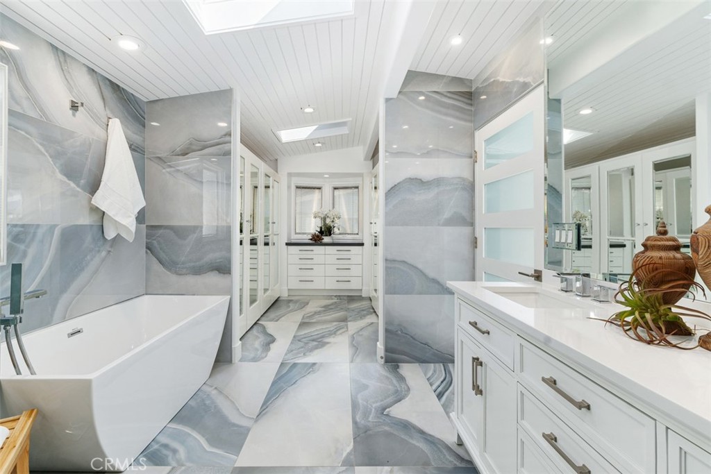 35261 Beach Road Dana Point, CA 92624 - Photo 31 of 45 a bathroom with a tub sink double vanity granite and shower