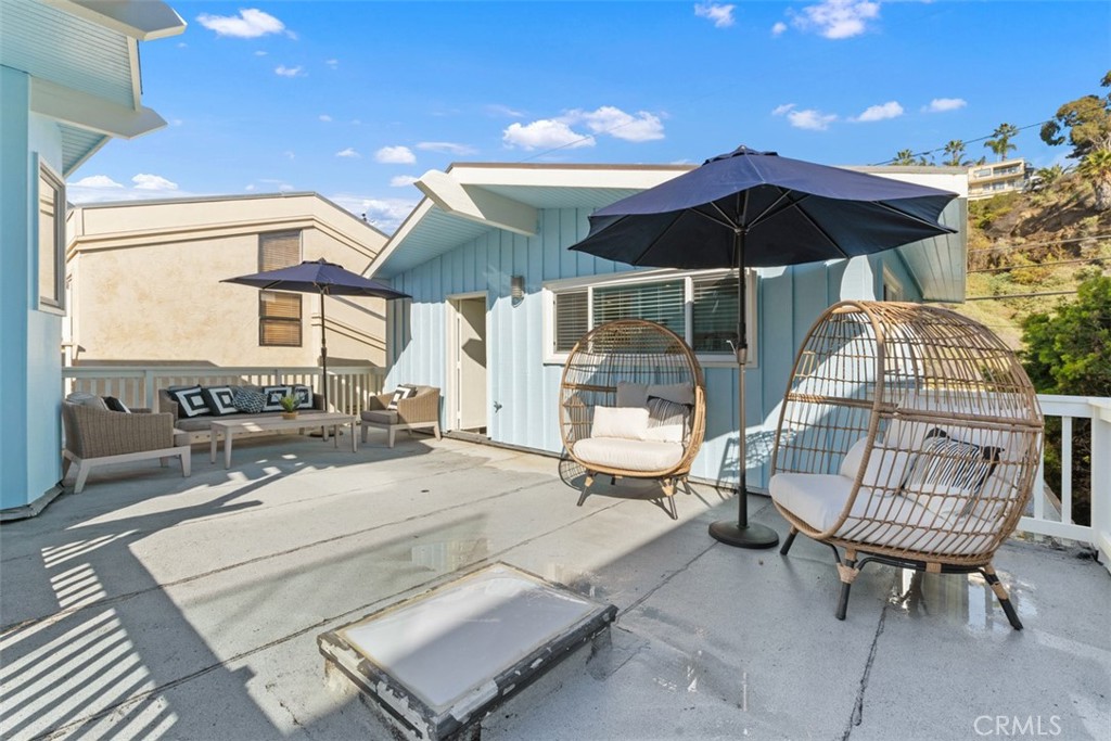 35261 Beach Road Dana Point, CA 92624 - Photo 32 of 45 a view of a patio with a table and chairs under an umbrella