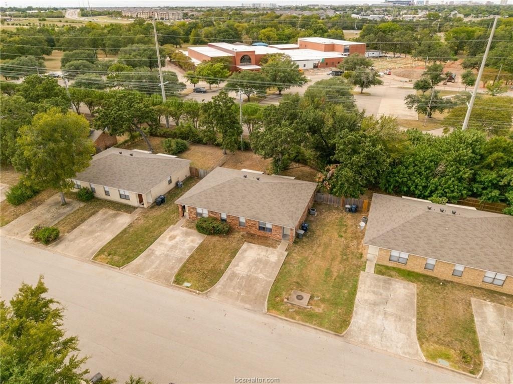 an aerial view of residential houses with outdoor space