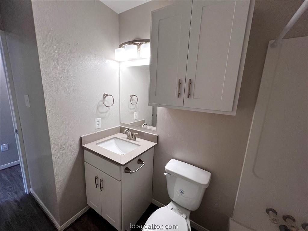 621 West Ridge Drive College Station, TX 77845 - Photo 11 of 13 a bathroom with a toilet sink and mirror