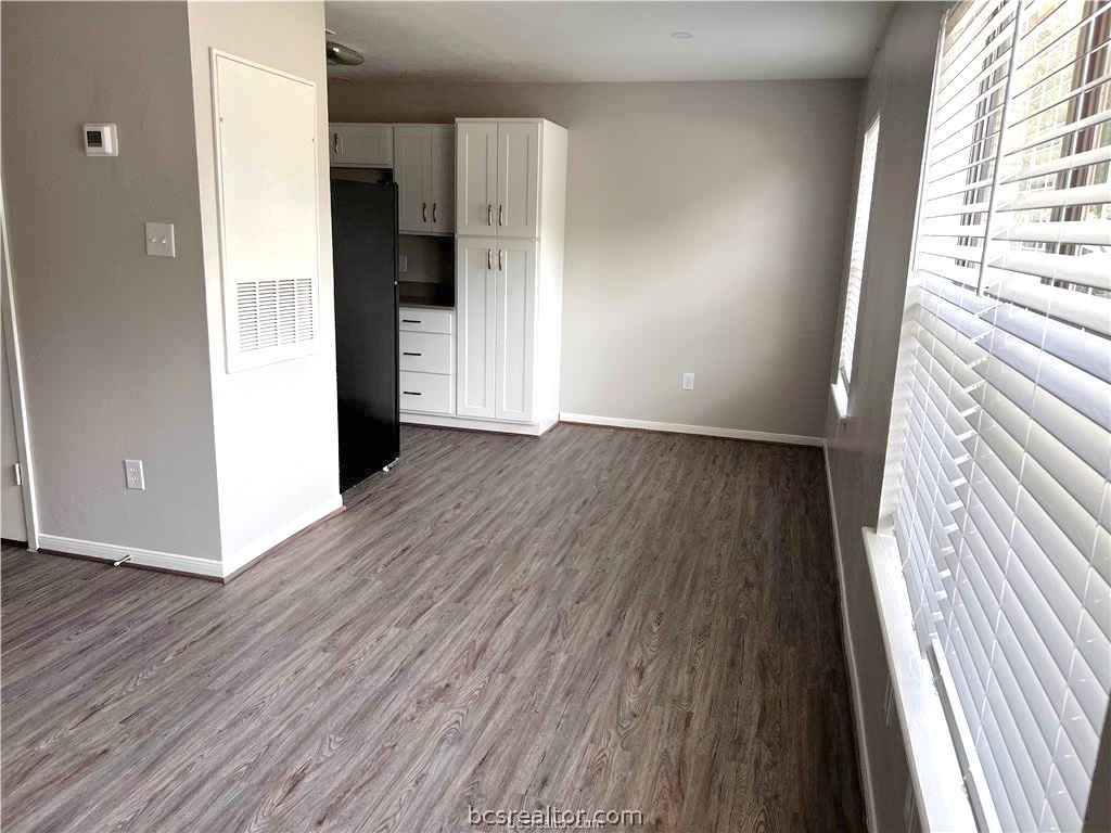 621 West Ridge Drive College Station, TX 77845 - Photo 4 of 13 a view of an empty room with wooden floor and a window