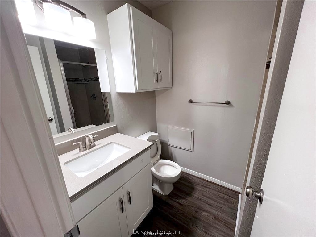 621 West Ridge Drive College Station, TX 77845 - Photo 7 of 13 a bathroom with a granite countertop sink toilet and mirror