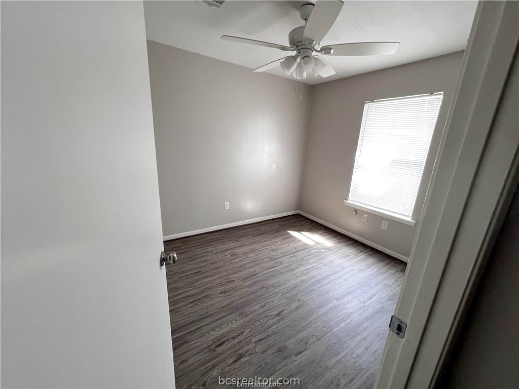 621 West Ridge Drive College Station, TX 77845 - Photo 9 of 13 an empty room with wooden floor and windows