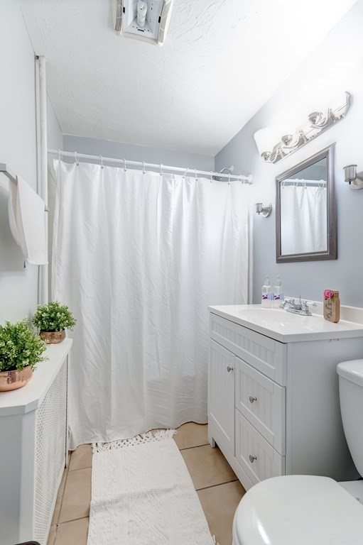 26 King Philip Road Worcester, MA 01606 - Photo 11 of 16 a bathroom with a granite countertop sink mirror vanity and toilet