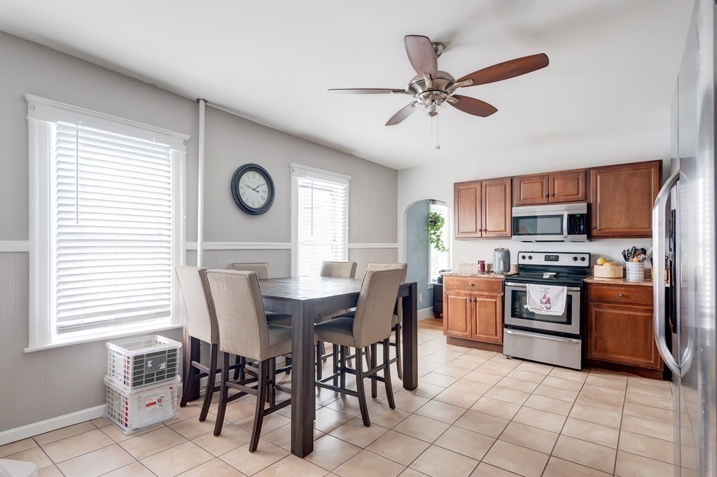 26 King Philip Road Worcester, MA 01606 - Photo 5 of 16 a kitchen with stainless steel appliances granite countertop a stove top oven a sink a dining table and chairs