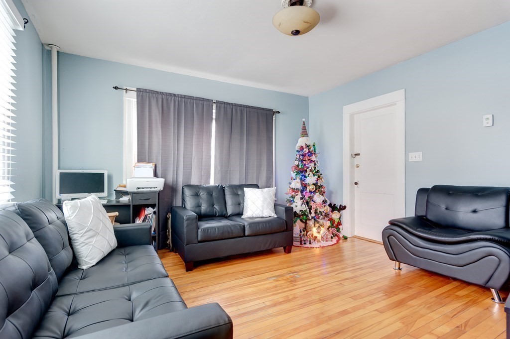 26 King Philip Road Worcester, MA 01606 - Photo 7 of 16 a living room with furniture and flowers