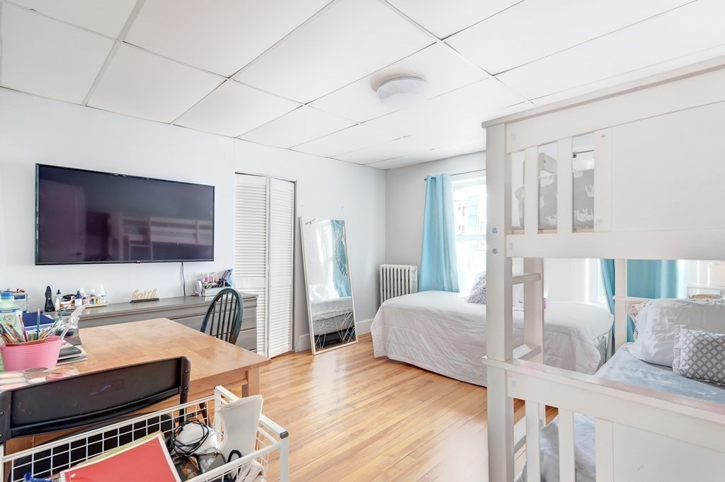 26 King Philip Road Worcester, MA 01606 - Photo 10 of 16 a bedroom with furniture and a flat screen tv