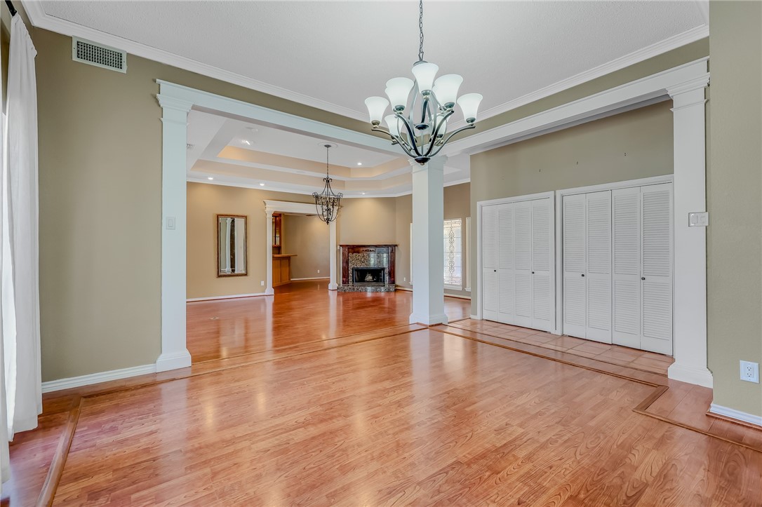 5917 Harvest Hill Road Corpus Christi, TX 78414 - Photo 9 of 40 a view of an empty room with wooden floor and a kitchen