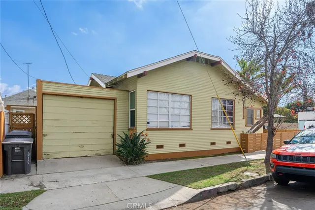 a view of a house with a backyard and garage