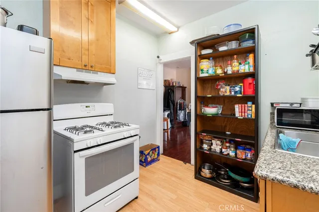 a kitchen with stainless steel appliances granite countertop a stove and a refrigerator