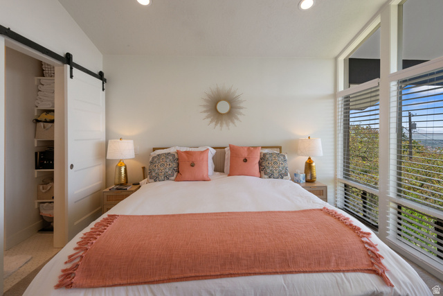 1900 North 100 East Provo, UT 84604 - Photo 17 of 49 Recessed lighting illuminates this bright room featuring a sliding barn door with exposed hardware, expansive windows, and a built-in closet organization system