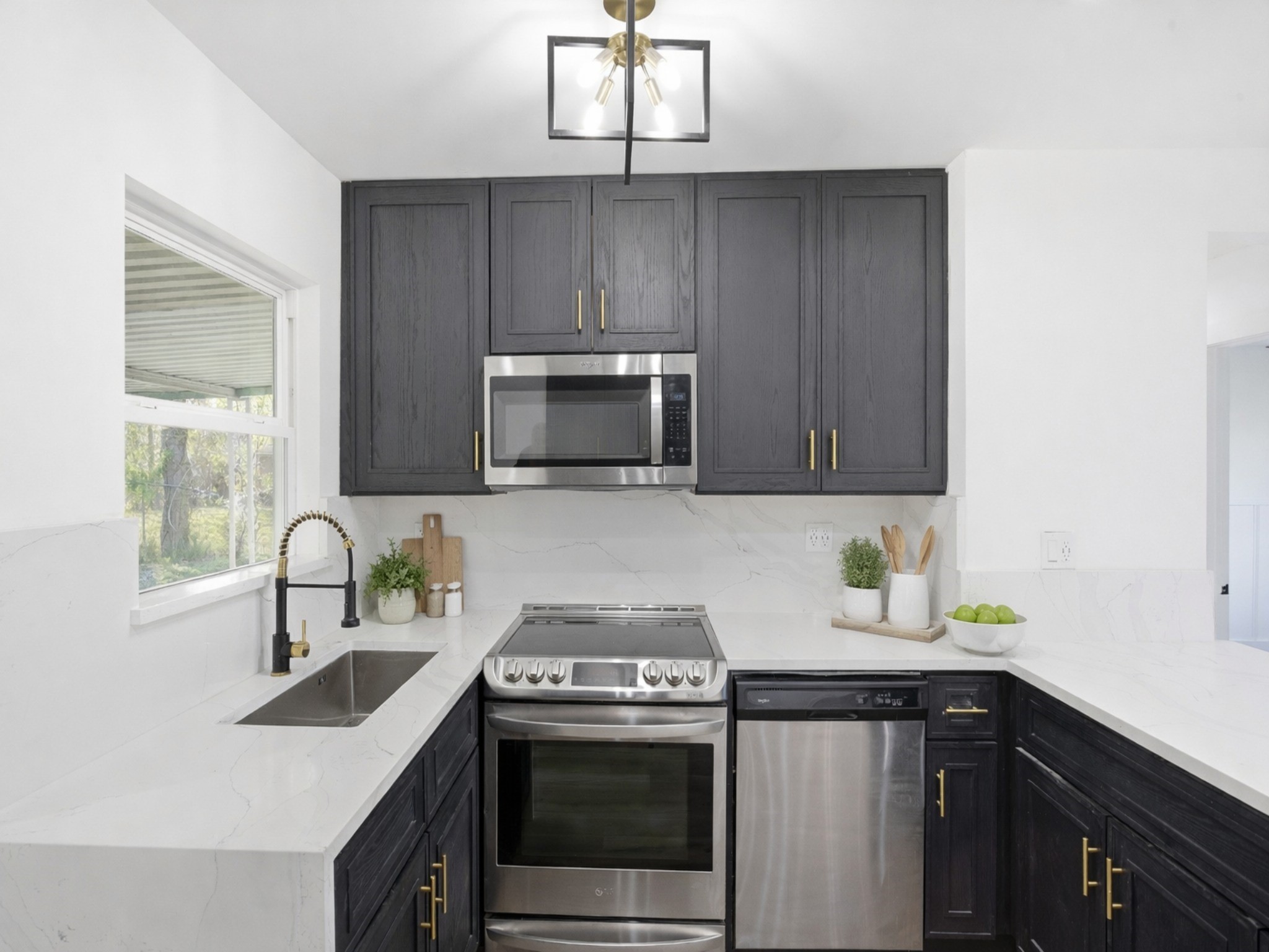 4516 Werner Street Houston, TX 77022 - Photo 3 of 28 Updated kitchen featuring black cabinetry, updated countertops, and new appliances for a modern, functional design.
*Photo is virtually staged.*