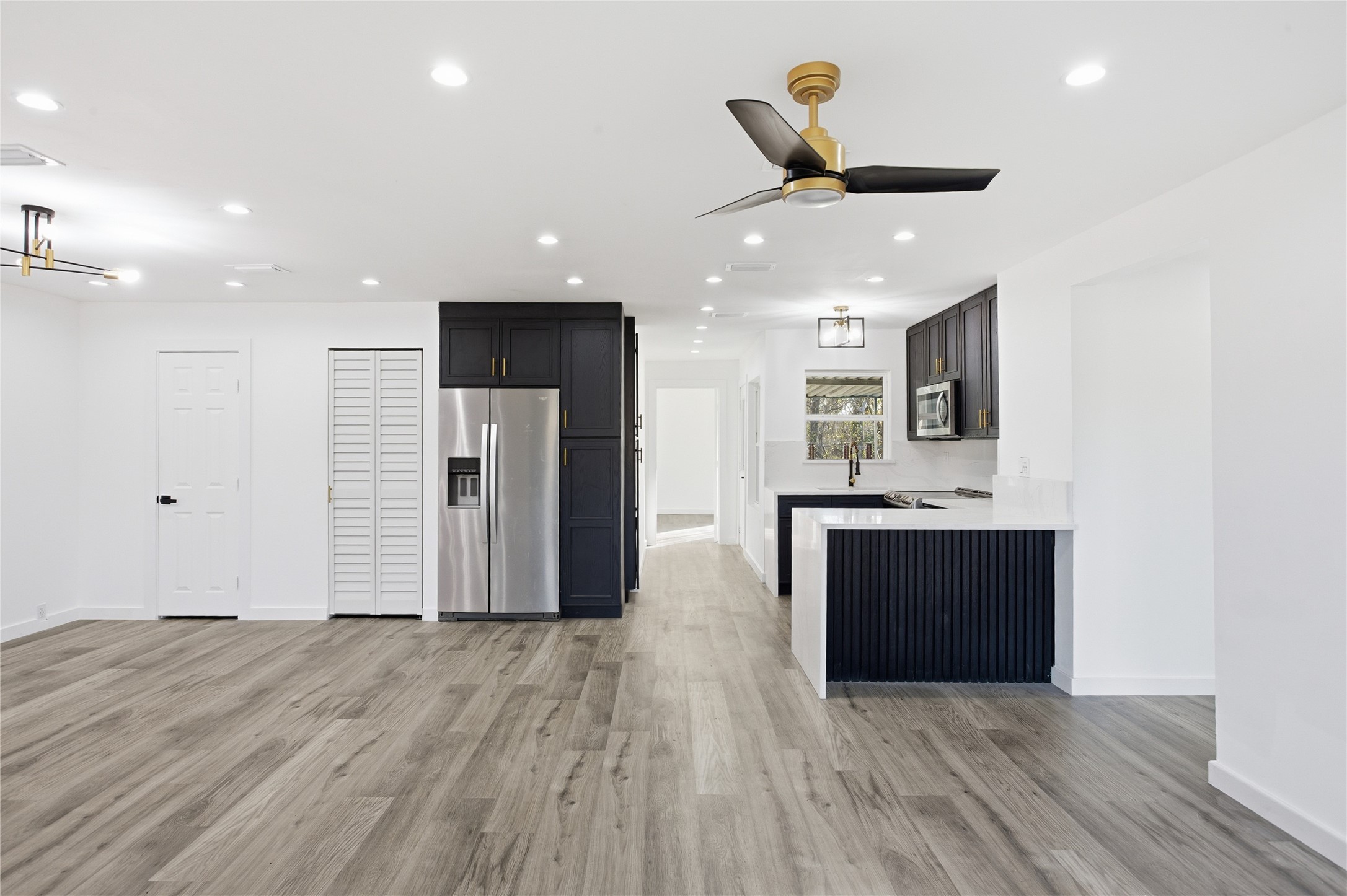 4516 Werner Street Houston, TX 77022 - Photo 6 of 28 Gold accents throughout the home, along with a washer and dryer stored conveniently in the pantry doors.