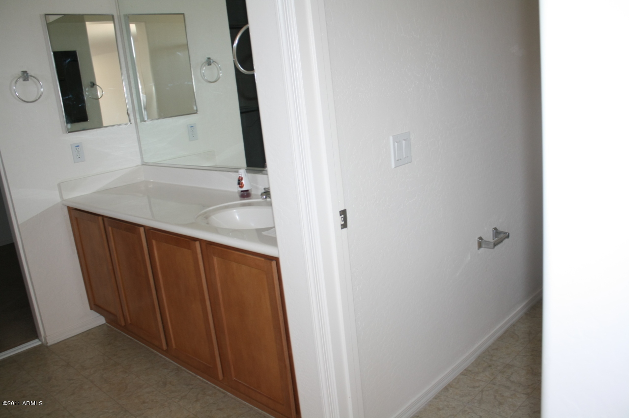 5114 West Apollo Road Laveen, AZ 85339 - Photo 13 of 17 a bathroom with a granite countertop sink and a mirror