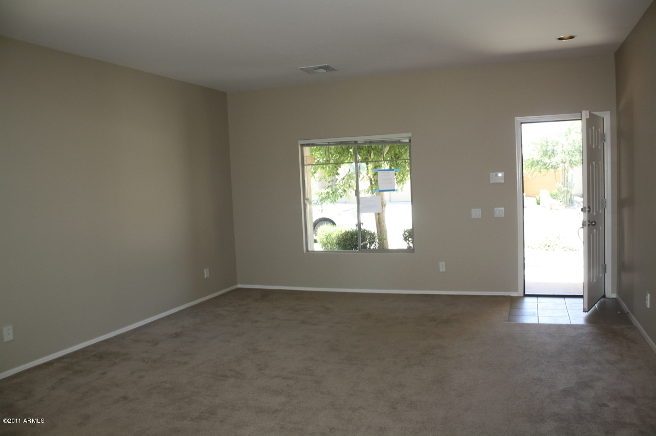 5114 West Apollo Road Laveen, AZ 85339 - Photo 2 of 17 an empty room with windows