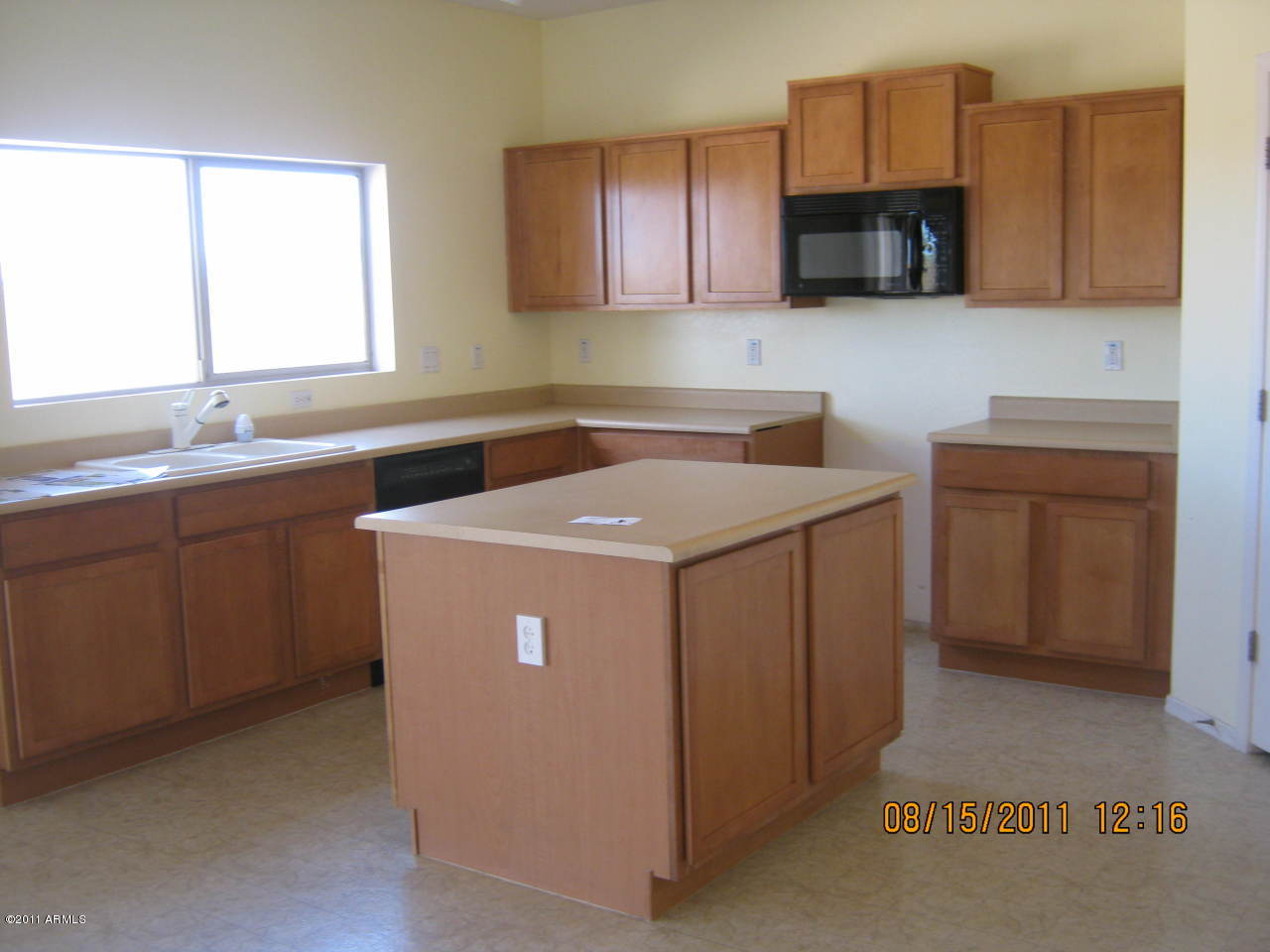 5114 West Apollo Road Laveen, AZ 85339 - Photo 4 of 17 a kitchen with a sink a stove and cabinets
