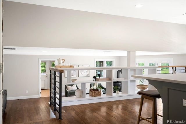 a view of a livingroom with furniture hardwood and a floor to ceiling window
