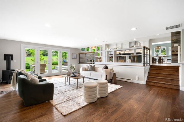 a living room with furniture and wooden floor