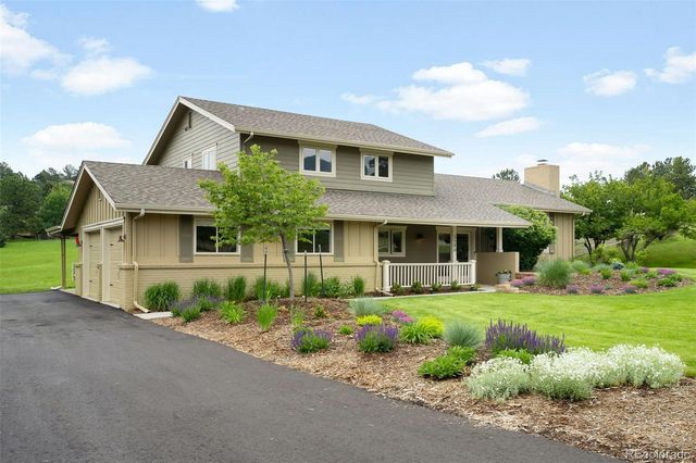 a front view of house with yard and green space