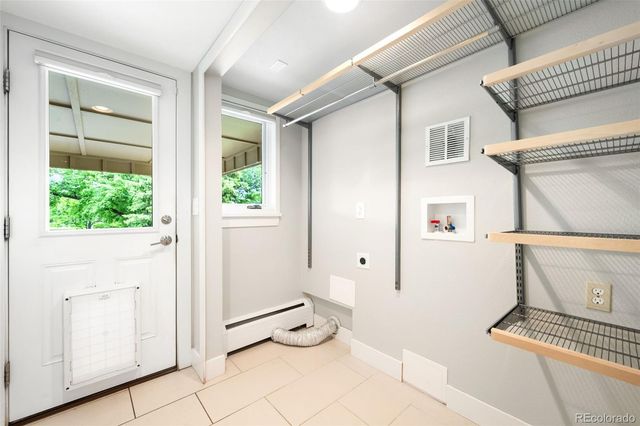 a view of a hallway with bathroom and wooden floor