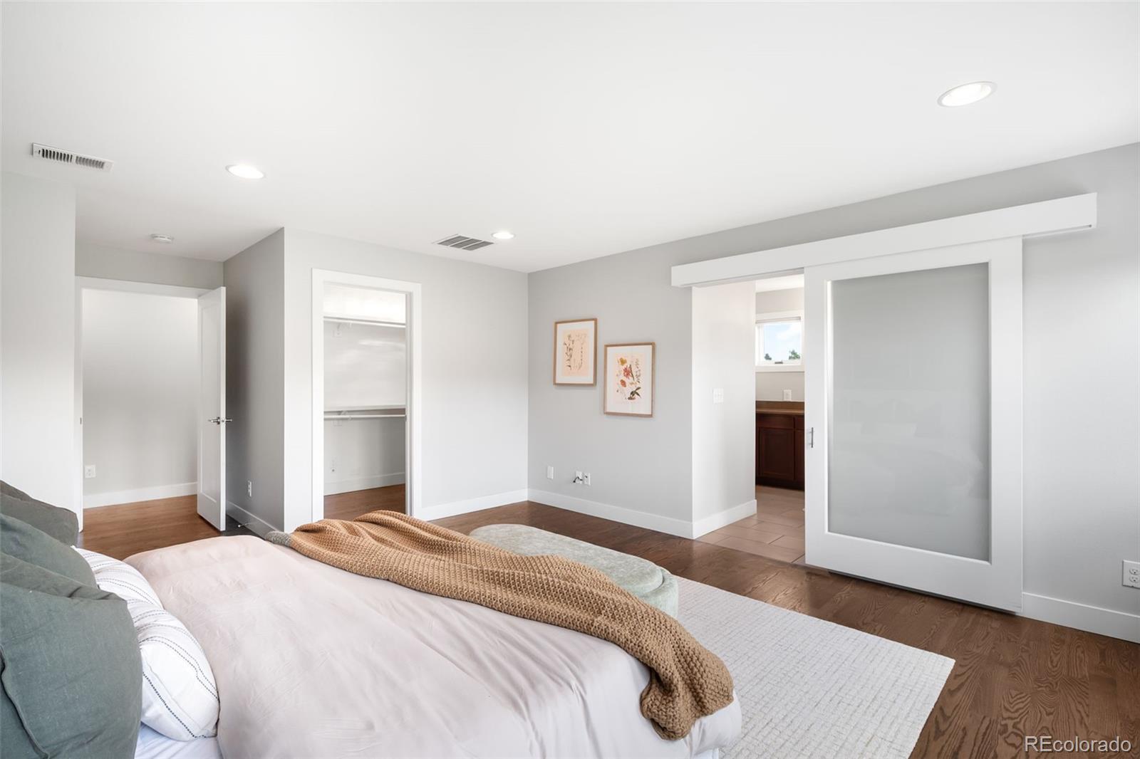 5586 Colorow Drive Morrison, CO 80465 - Photo 26 of 50 a bedroom with a bed and wooden floor