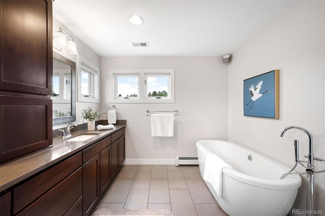 a large white kitchen with a sink a stove and a microwave