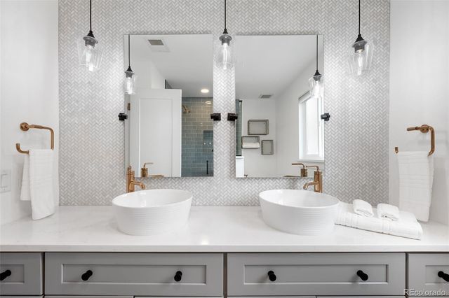 a bathroom with a sink a mirror and shower