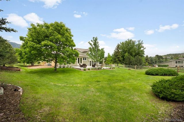 a view of house with garden space and trees