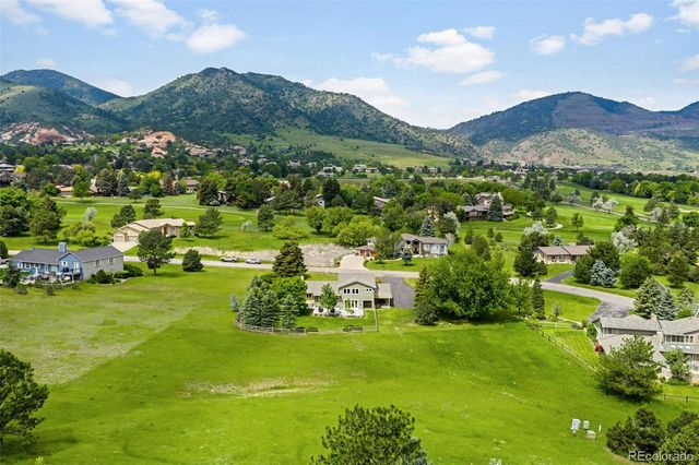 a view of a lush green hillside and houses