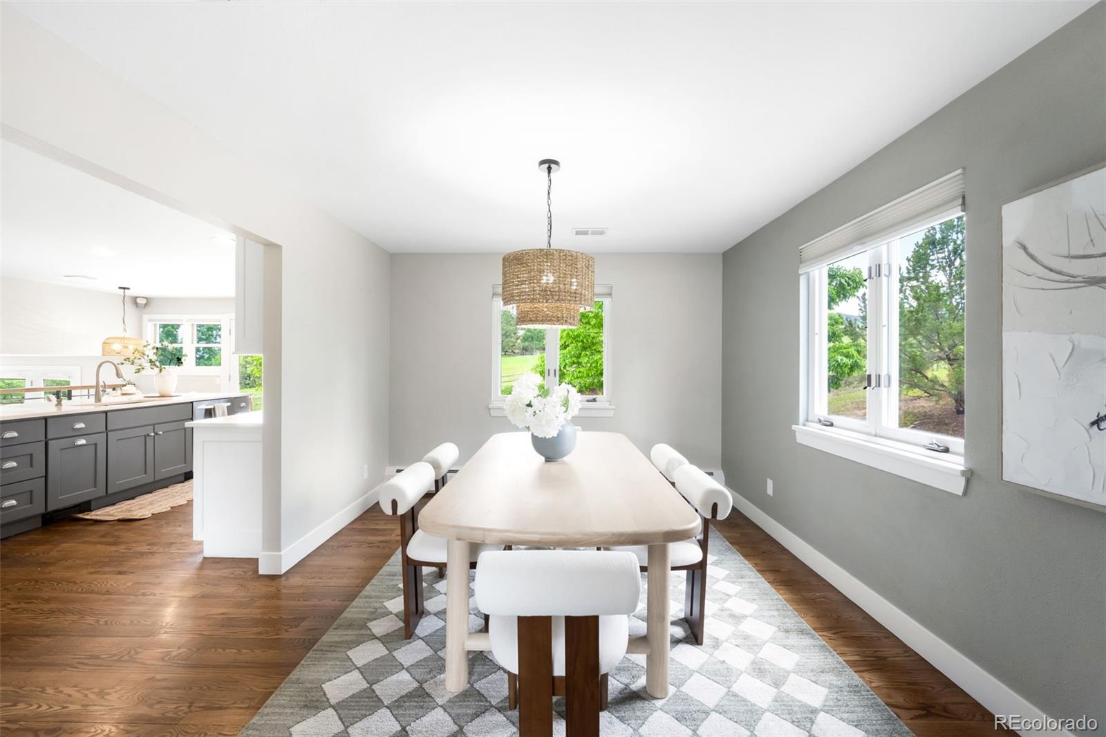 5586 Colorow Drive Morrison, CO 80465 - Photo 8 of 50 a dining room with wooden floor a chandelier a wooden table and chairs