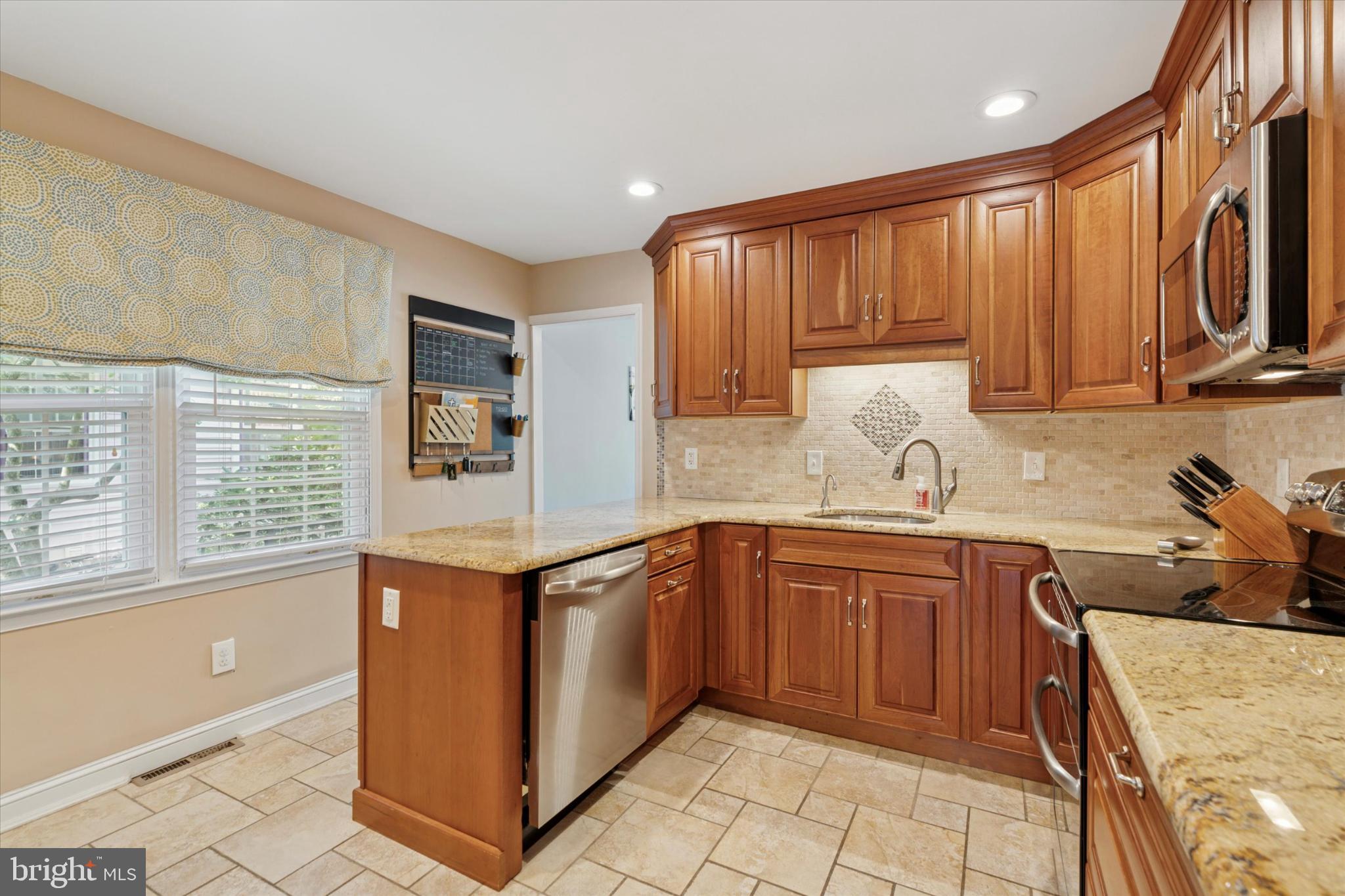 101 Rockland Road Havertown, PA 19083 - Photo 6 of 35 a kitchen with stainless steel appliances granite countertop a stove a sink dishwasher and a refrigerator