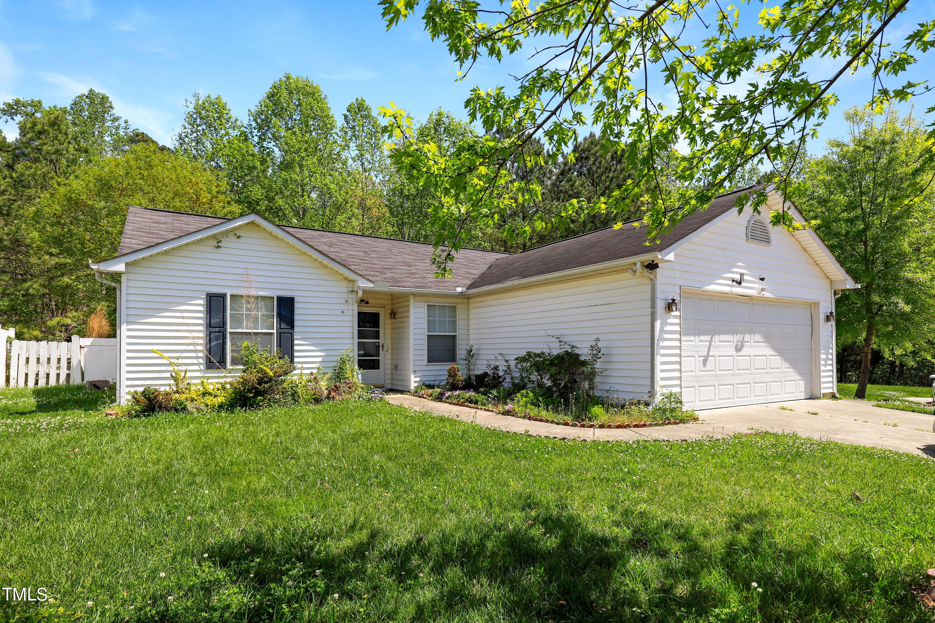 3809 Buck Ridge Court Raleigh, NC 27616 - Photo 1 of 10 a front view of house with yard and green space