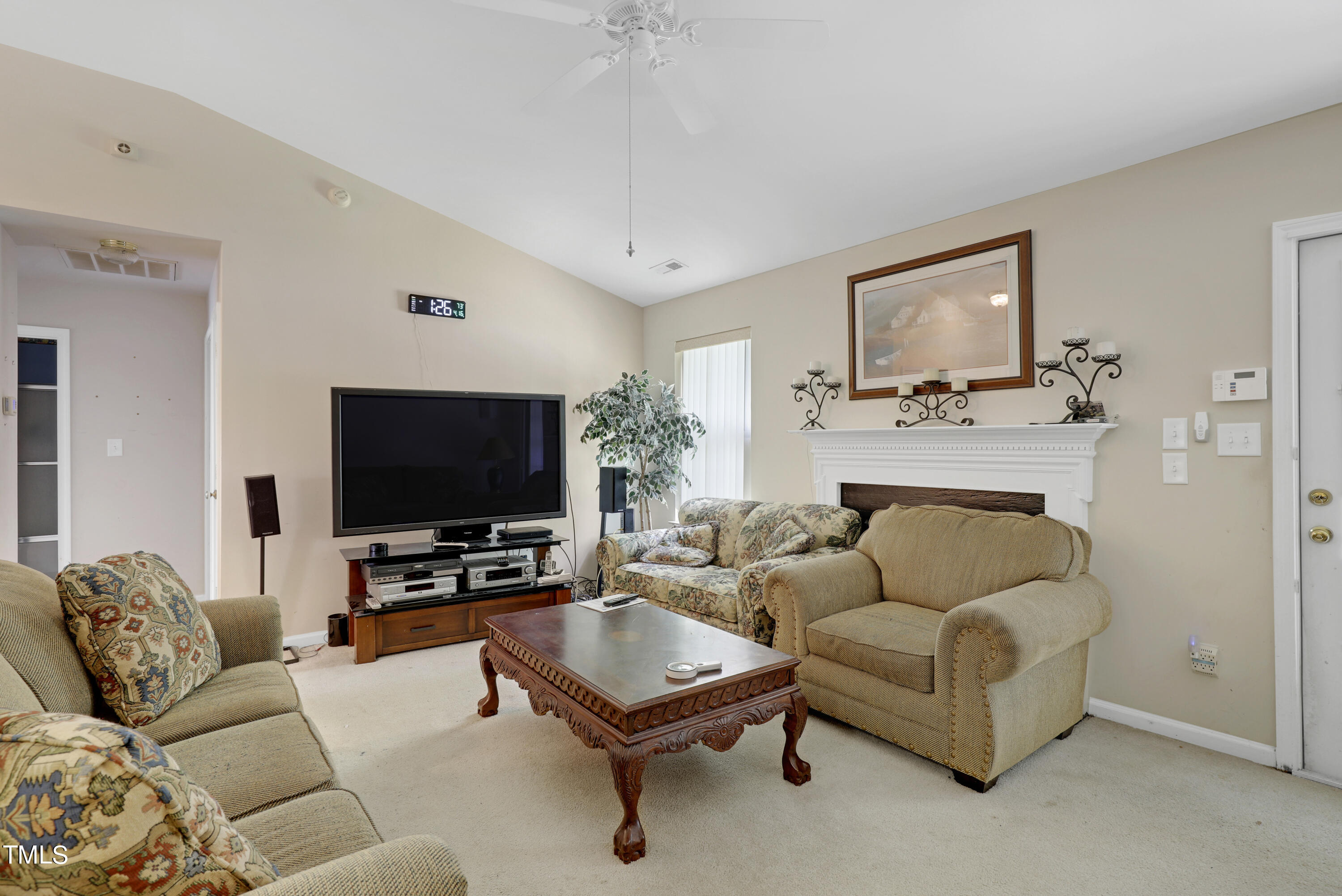 3809 Buck Ridge Court Raleigh, NC 27616 - Photo 4 of 10 a living room with furniture and a flat screen tv