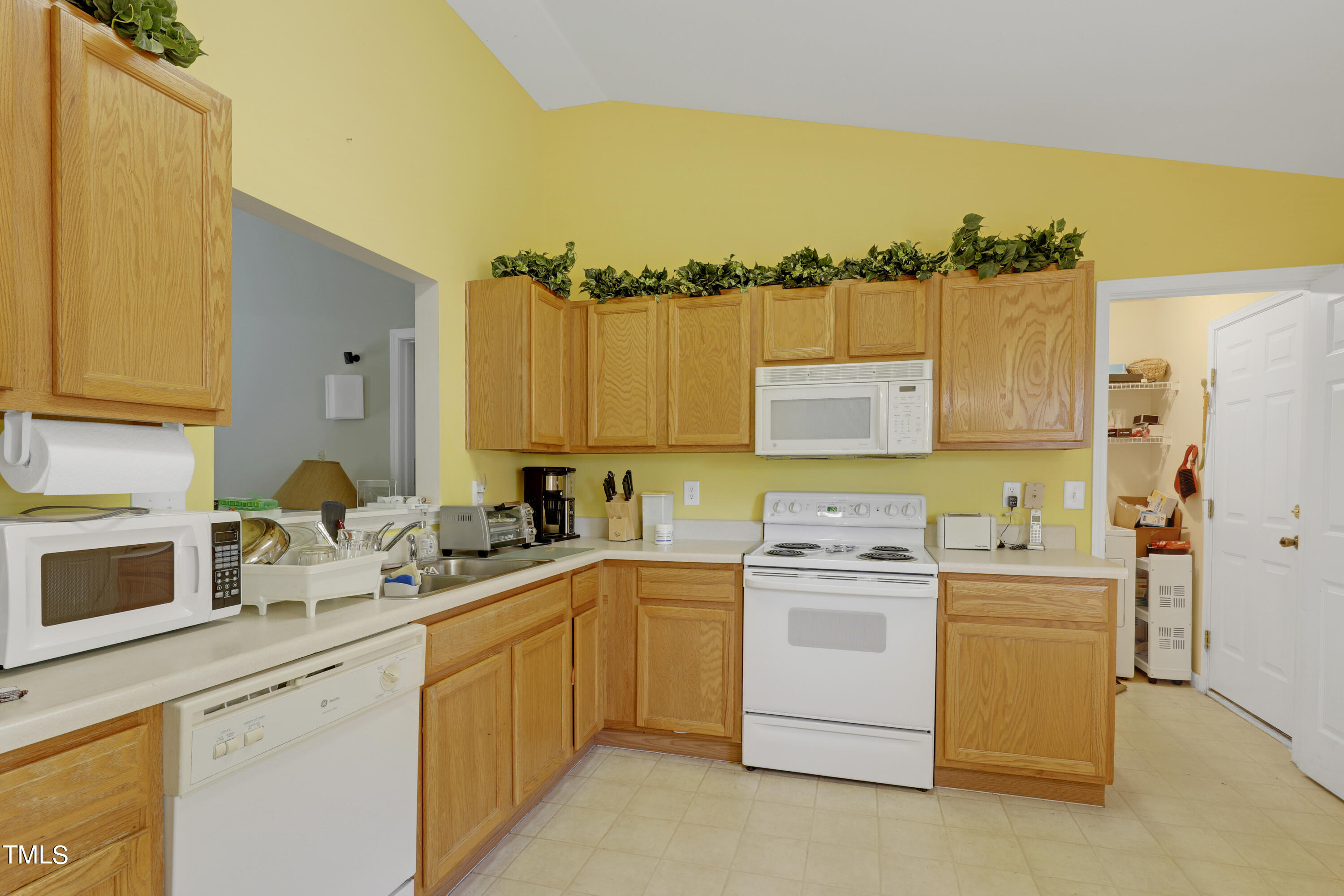 3809 Buck Ridge Court Raleigh, NC 27616 - Photo 5 of 10 a kitchen with a sink stove and refrigerator